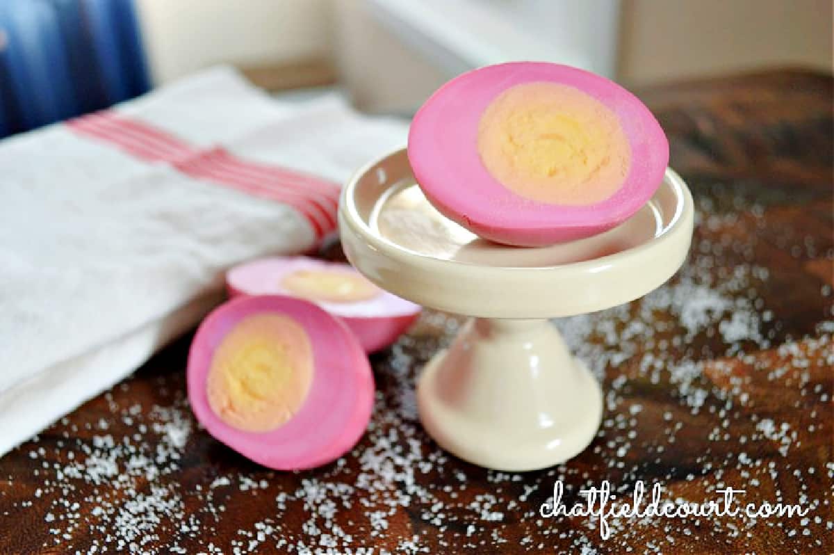 pickled eggs sliced in half on cutting board