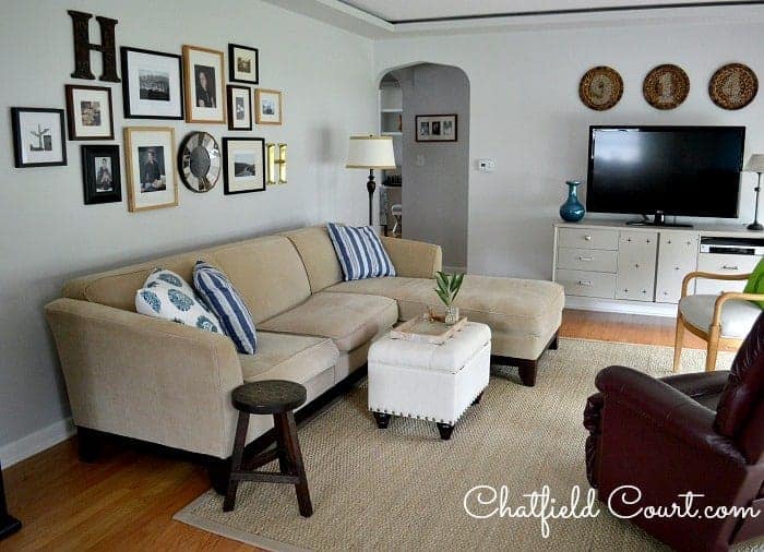 sectional in living room with gallery wall and dark gray painted walls