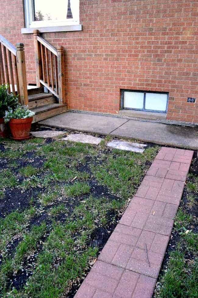 exterior view of small basement window on brick house