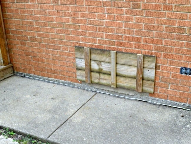 old wood attached to a brick house to create a shutter