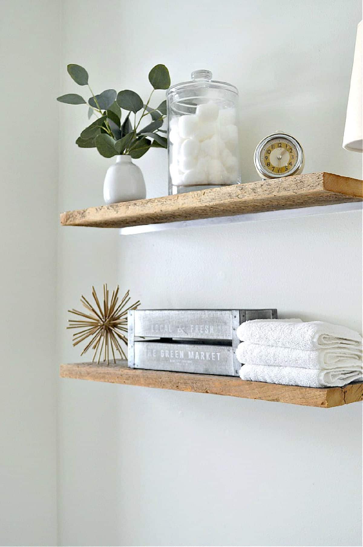 wood shelves on bathroom wall with toiletries