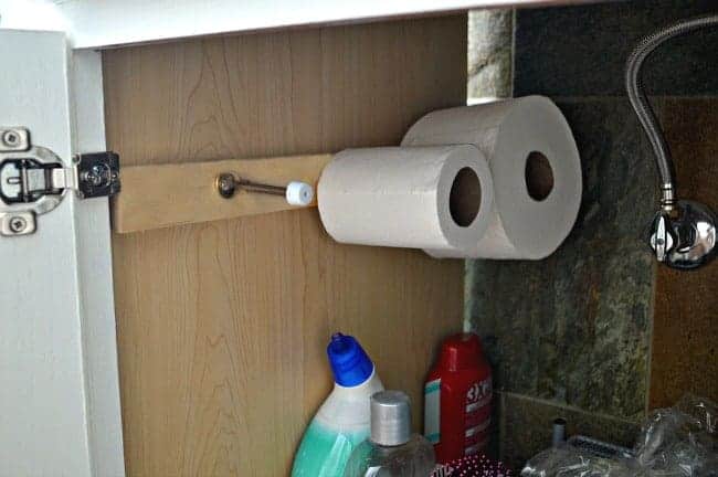 A DIY toilet paper holder helps with bathroom organization
