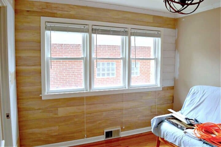 unpainted DIY shiplap wall in a guest bedroom