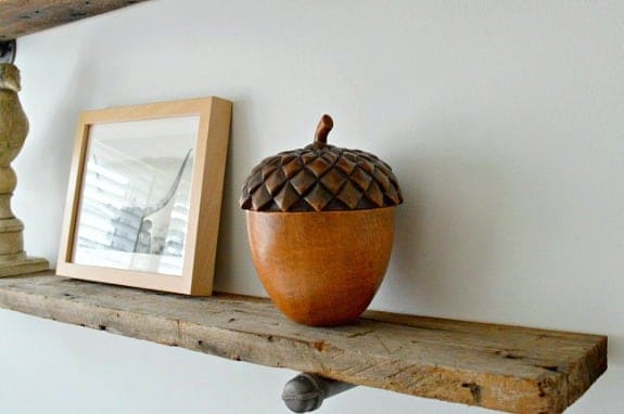 barn wood shelf with wooden acorn on it