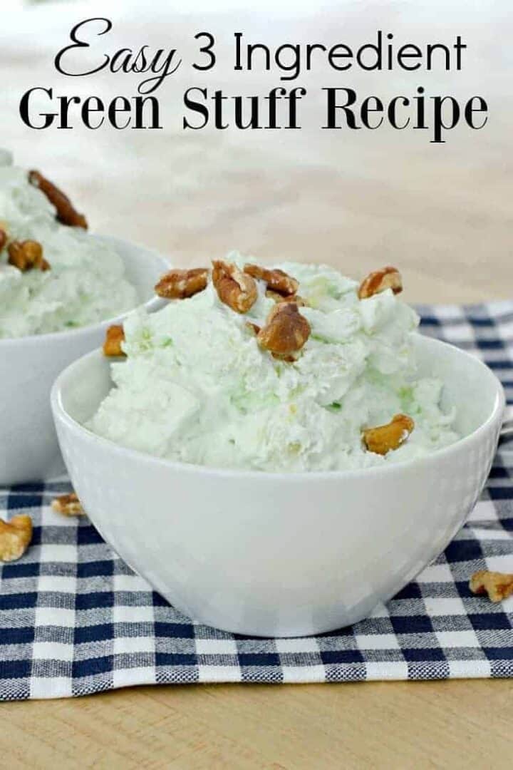 green stuff in small white bowl with nuts on top