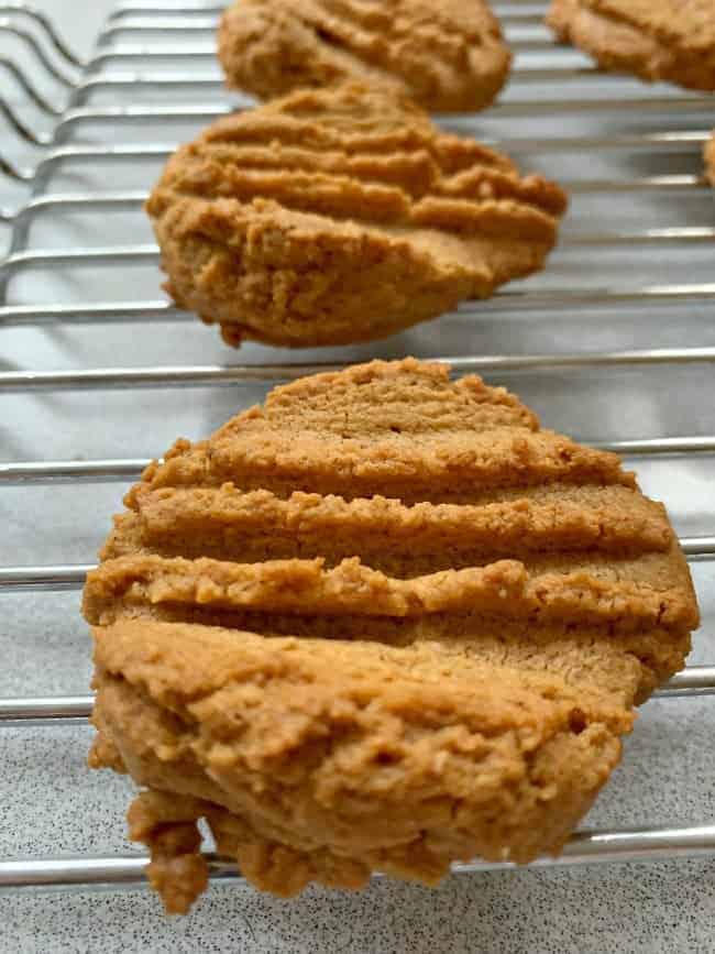 warm peanut butter cookies cooling on rack