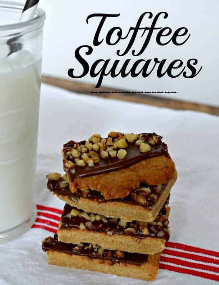 toffee bars stacked on top of each other with a glass of milk