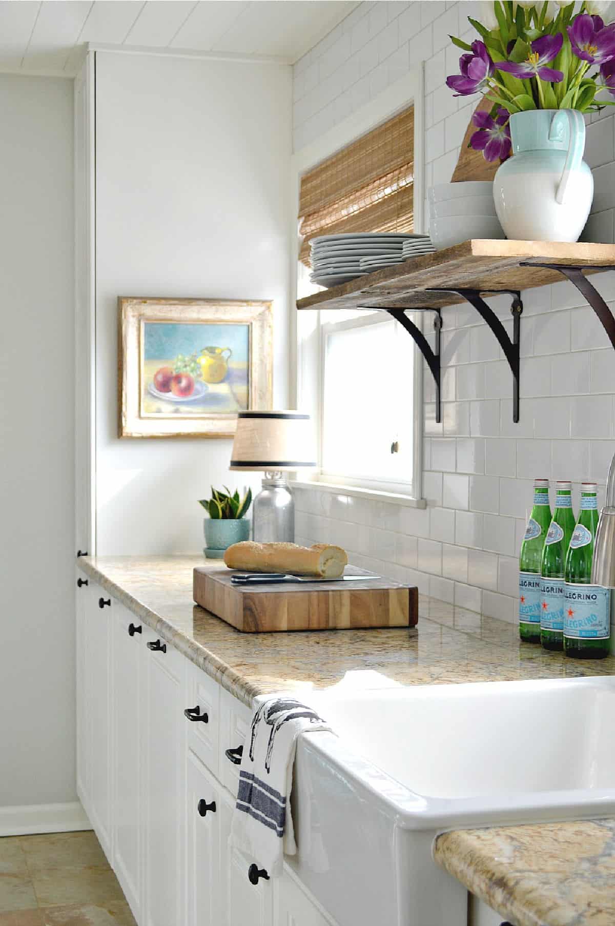 galley kitchen cabinets painted white with granite countertops