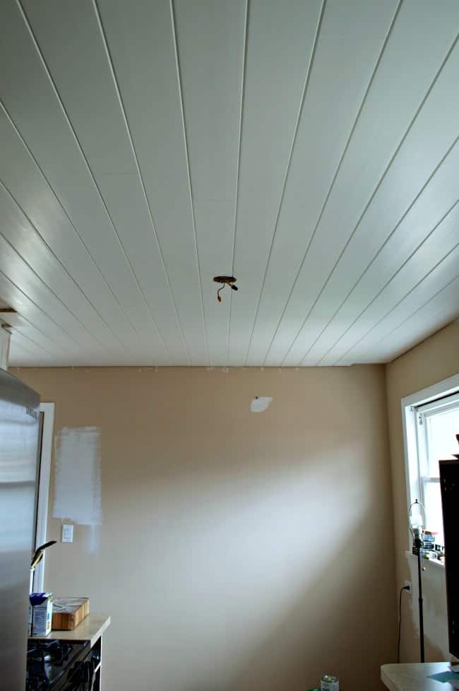 installed and painted tongue and groove ceiling planks in kitchen