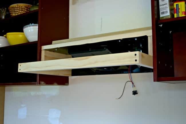 wood frame of custom DIY range hood between two cabinets