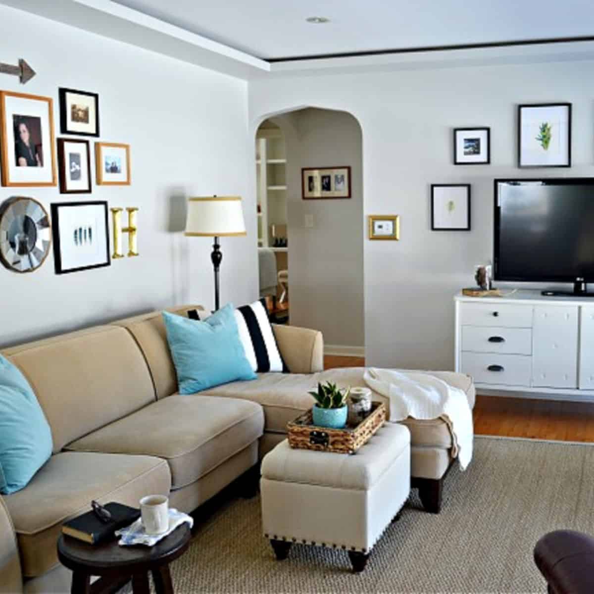 small living room with sectional sofa and ottoman