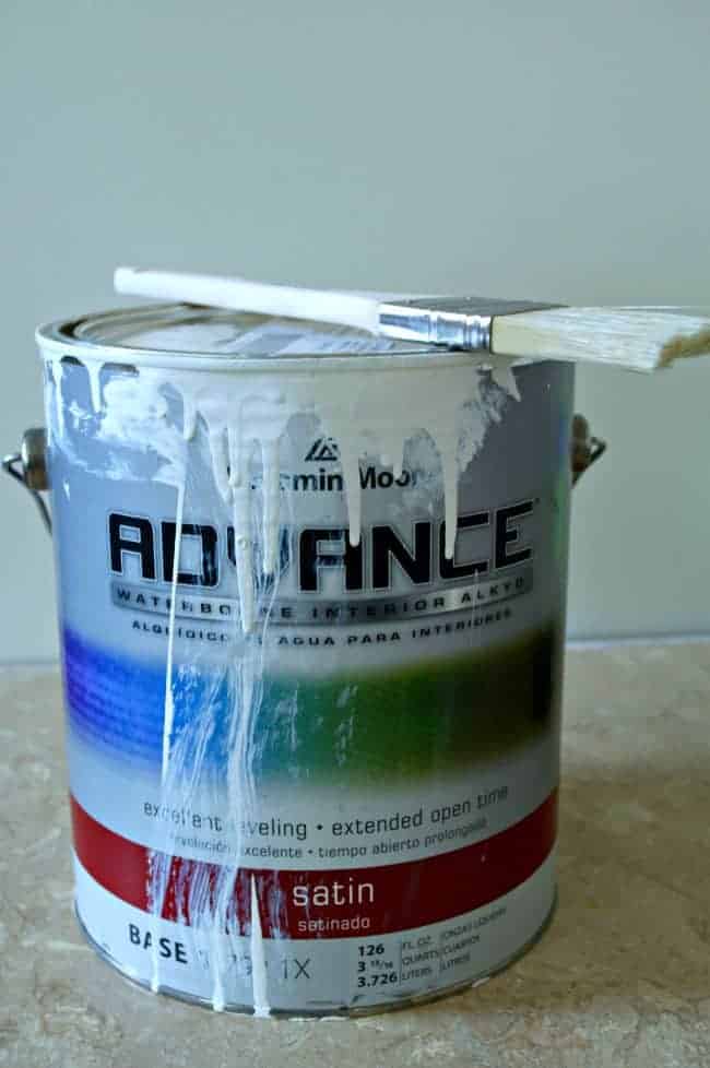 can of Benjamin Moore paint with paint brush on top