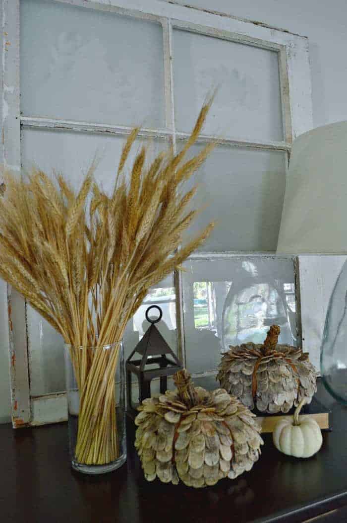 Pretty fall vignette with wheat stalks, a lantern and natural rustic pumpkins from Target. | www.chatfieldcourt.com