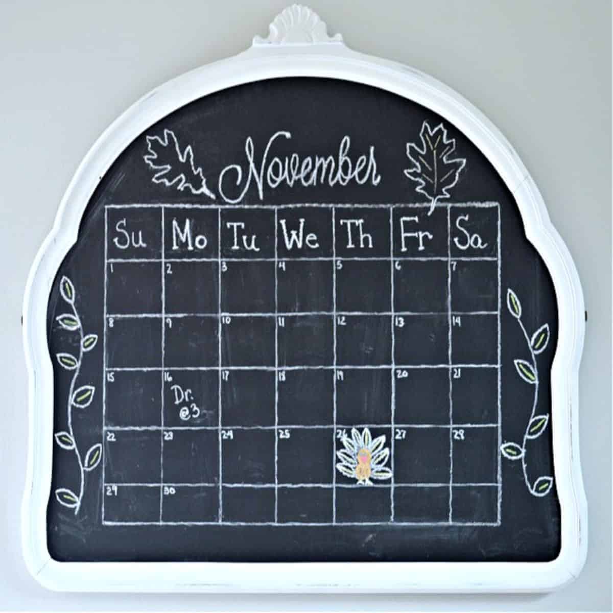 mirror turned DIY chalkboard with a calendar on it