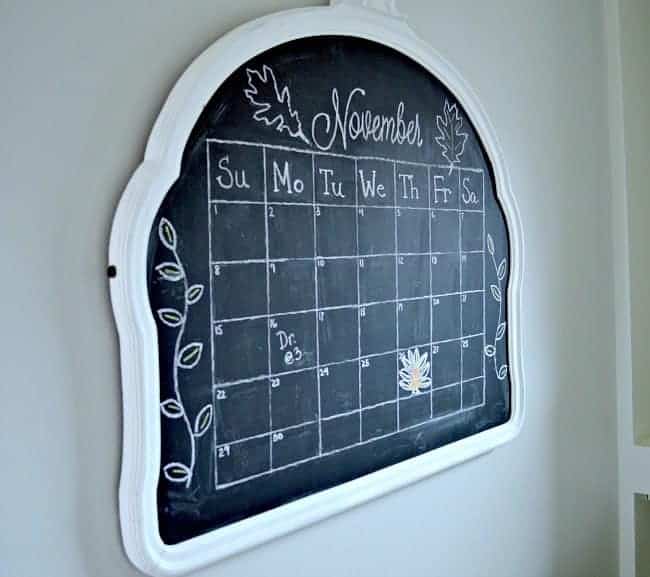 Vintage mirror turned into a kitchen chalkboard with a monthly calendar