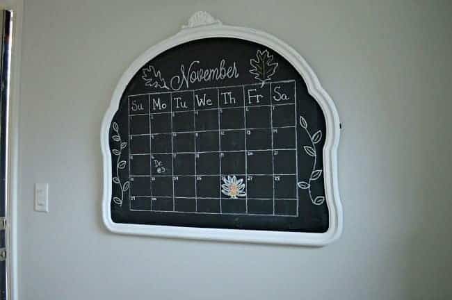 Vintage mirror turned into a kitchen chalkboard with a calendar 