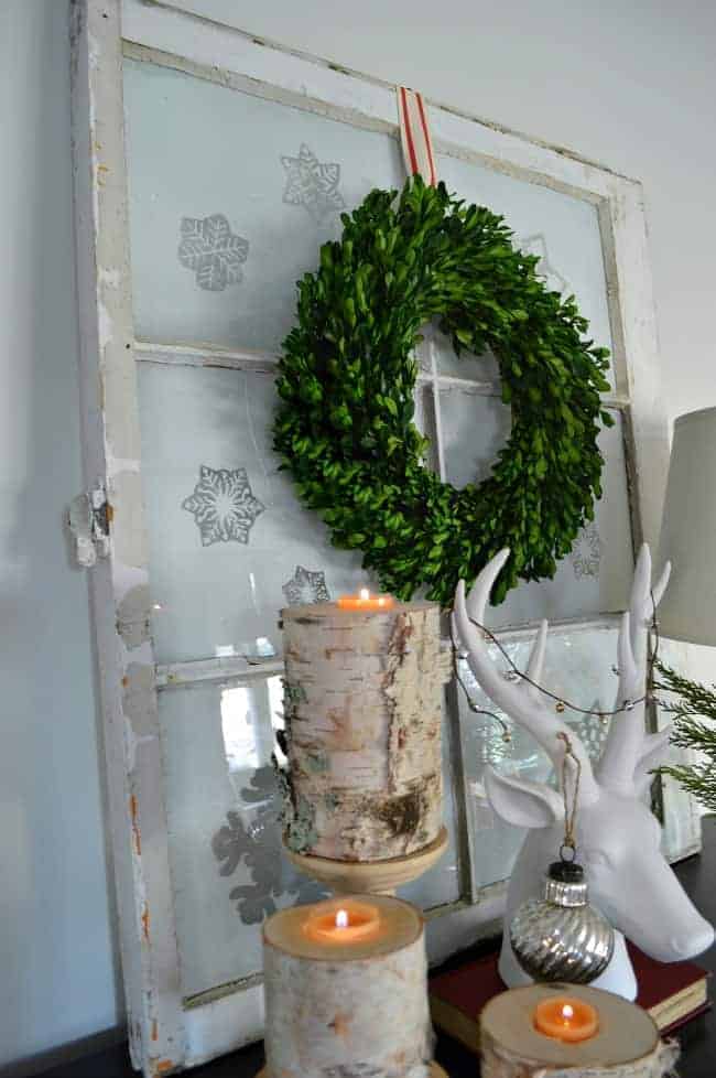 A Christmas living room decorated with lots of plaid, red and birch wood candle holders. | www.chatfieldcourt.com