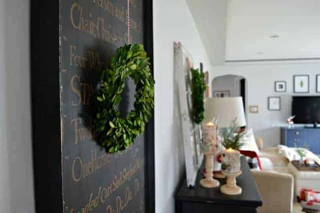 A Christmas living room decorated with lots of plaid, red and preserved boxwoods. | www.chatfieldcourt.com