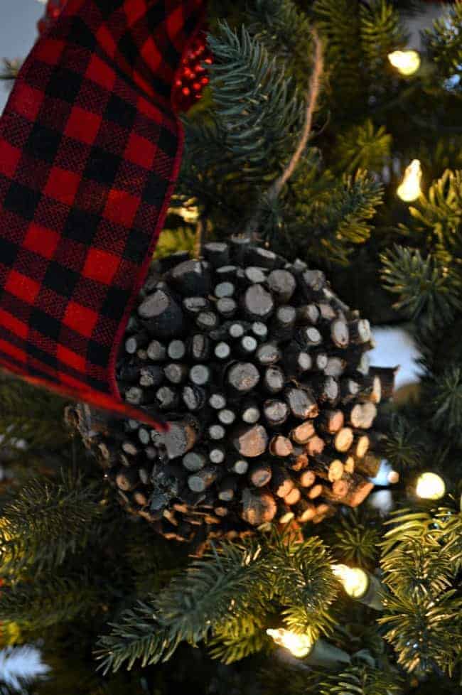 A Christmas living room decorated with lots of plaid, red and a rustic wood ornament on the tree. | www.chatfieldcourt.com