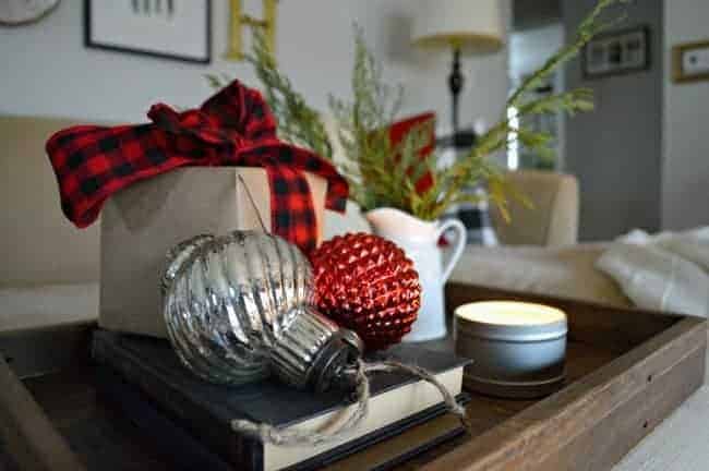 A Christmas living room decorated with lots of plaid, red, candles and greenery. | www.chatfieldcourt.com