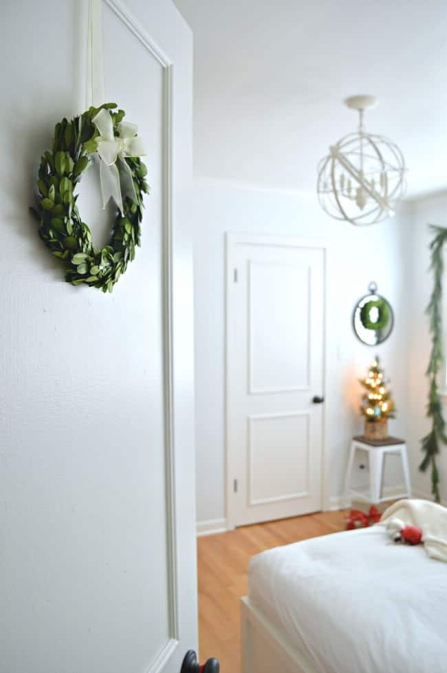 Christmas in the guest bedroom using green velvet on the platform bed and fresh greens | www.chatfieldcourt.com