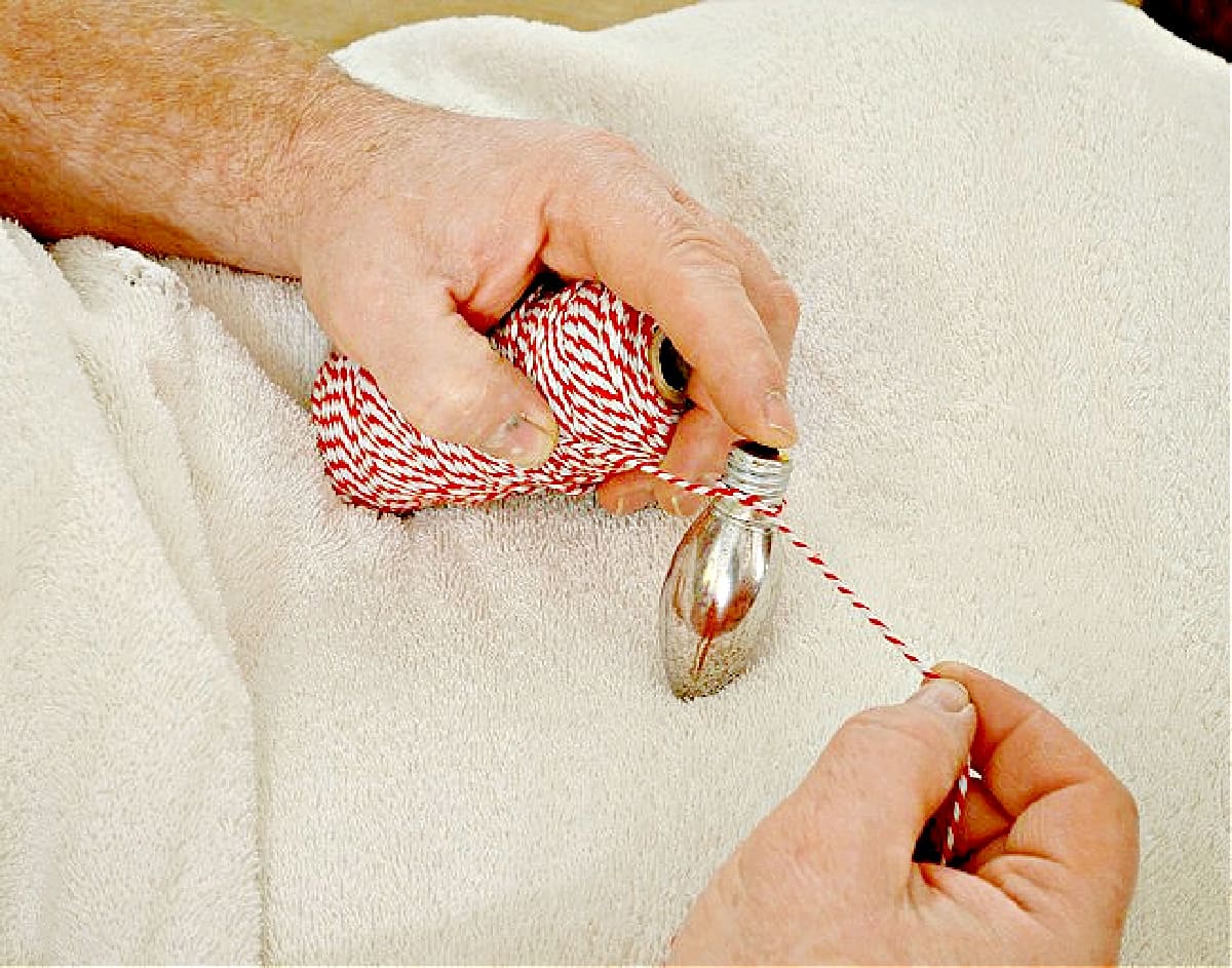 tying a light bulb with baker's twine