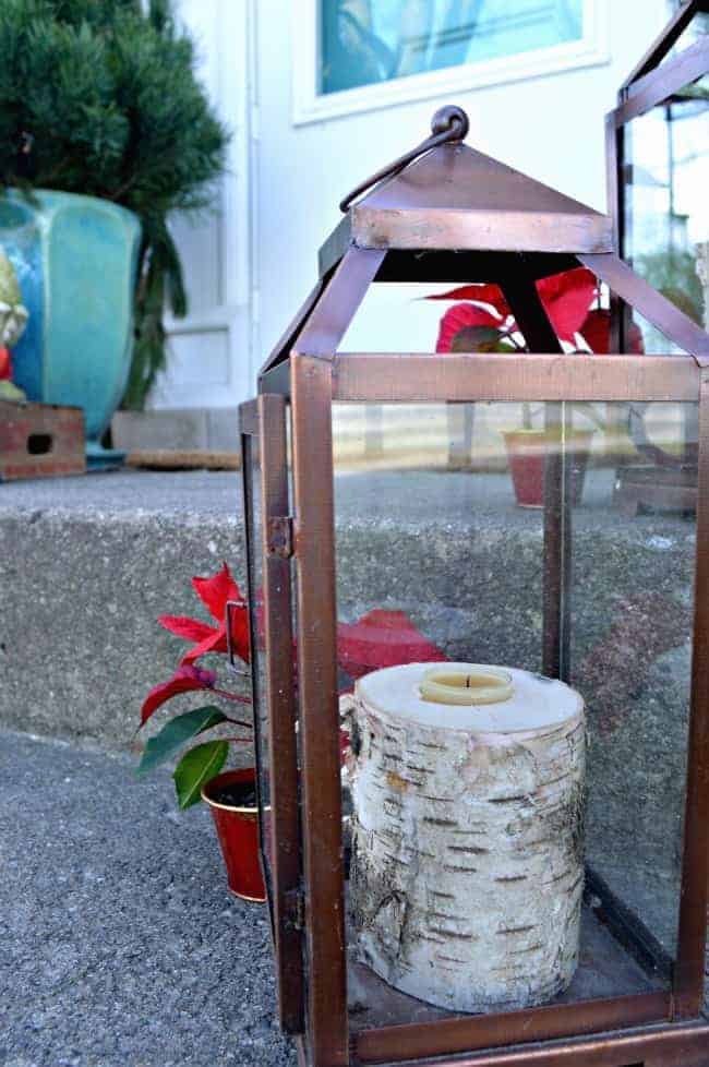 Christmas on our small front porch, which is decorated with birch log candle holders and greens | www.chatfieldcourt.com