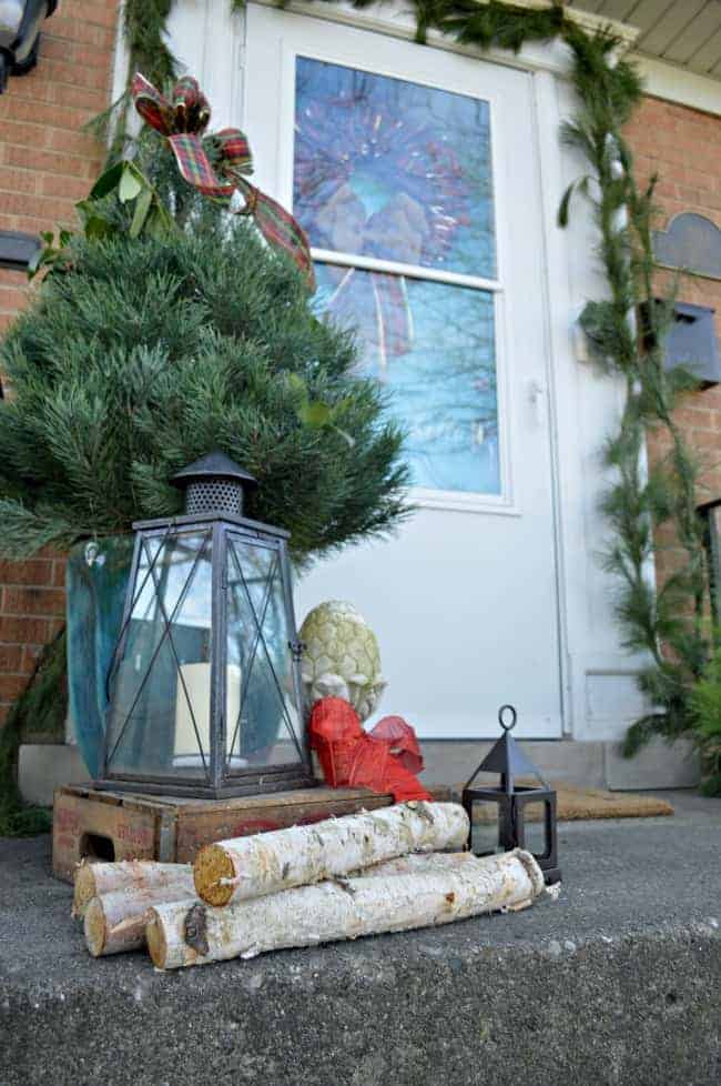 Christmas on our small front porch, which is decorated with a live mini Christmas tree, birch logs and greens | www.chatfieldcourt.com