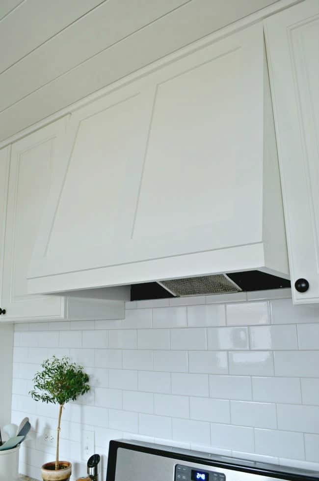 completed range hood and white subway tiled backsplash