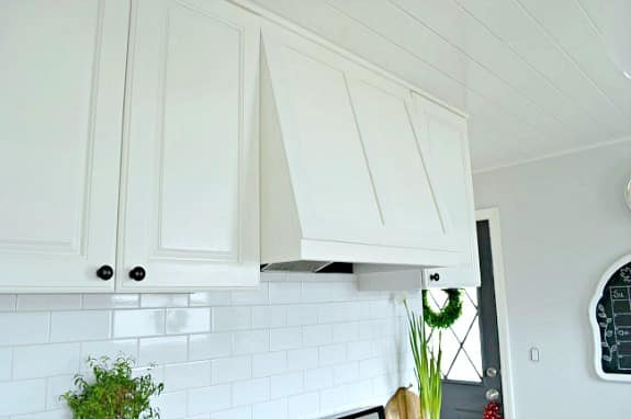 white painted cabinets and custom range hood