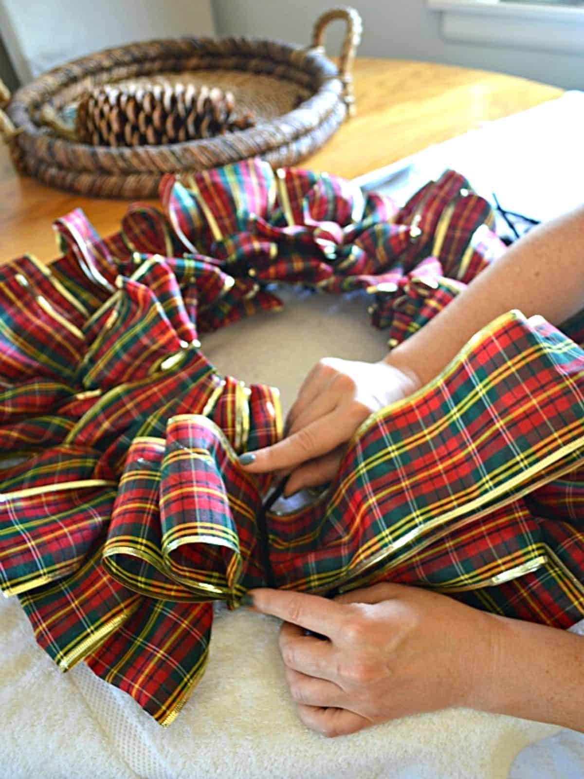 tying loop of ribbon wreath with pipe cleaner