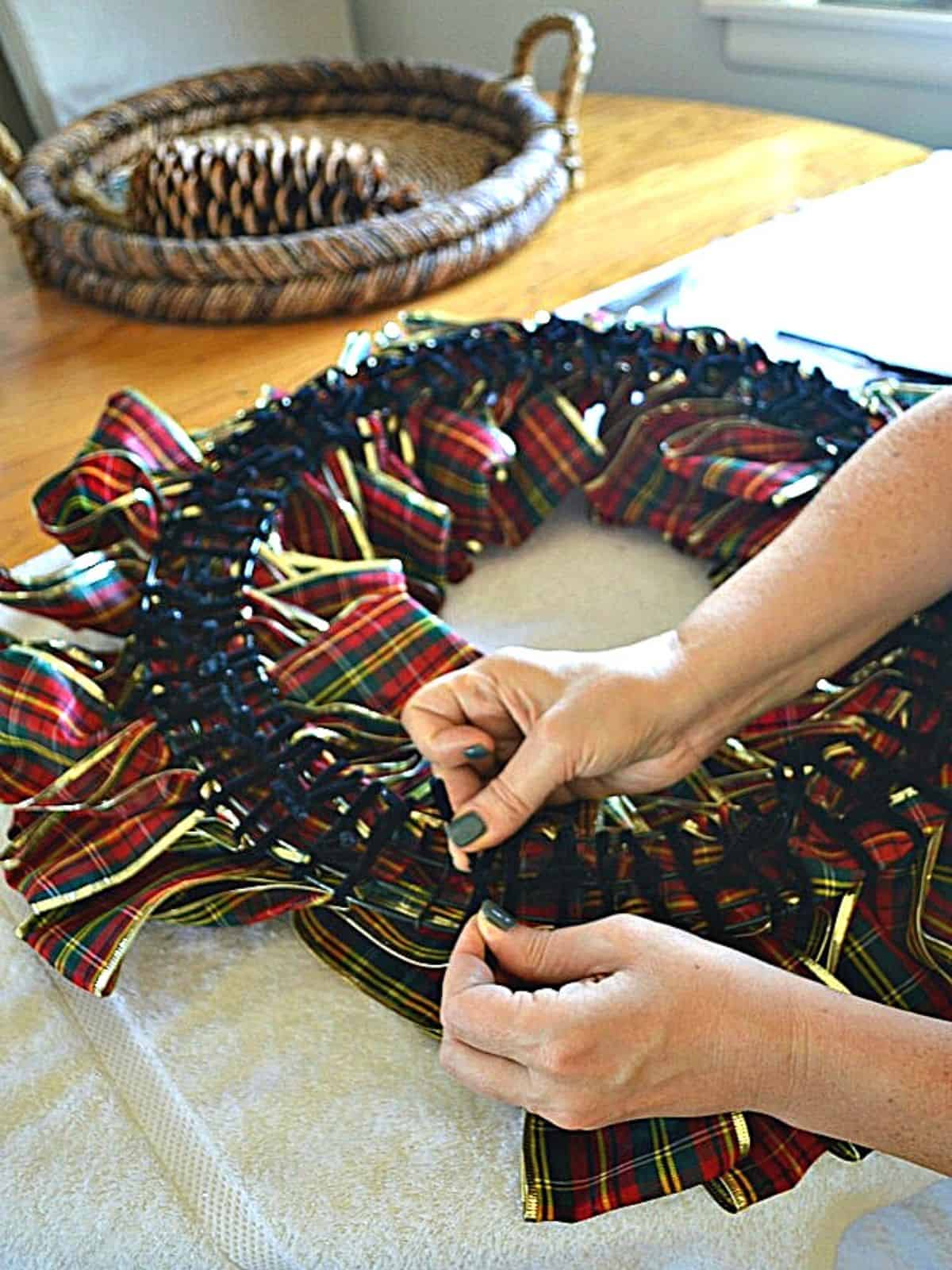 tying pipe cleaner on back of ribbon wreath