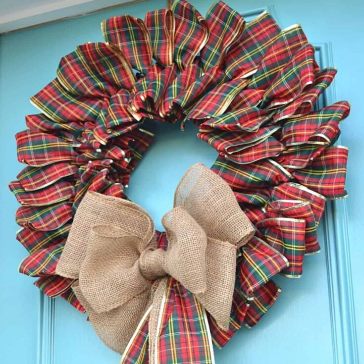 ribbon wreath hanging on turquoise front door