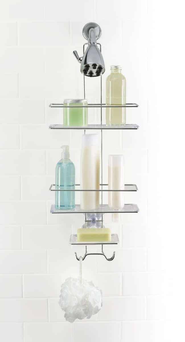 soaps and shampoos on shower caddy in white tiled shower