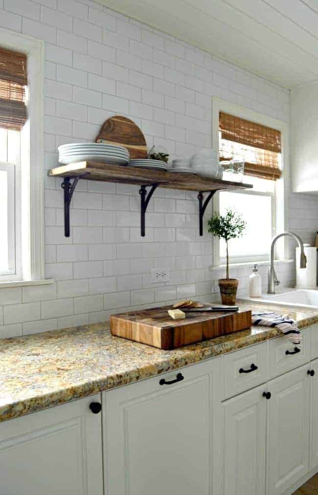 How we installed a rustic barn wood shelf on a tiled backsplash to add extra storage in a small kitchen. | www.chatfieldcourt.com