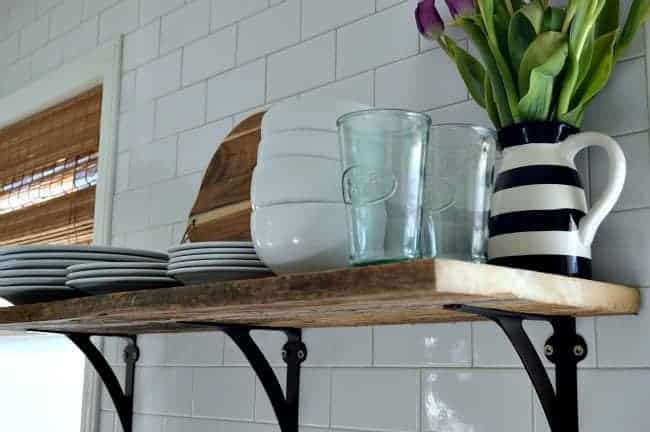 Install a rustic barn wood shelf to add extra storage in a small kitchen. | www.chatfieldcourt.com