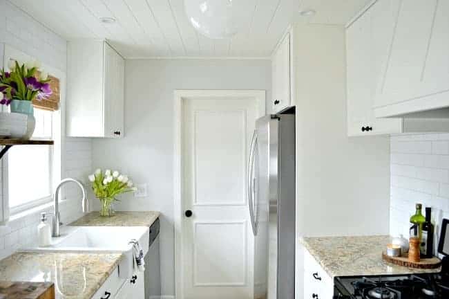 white kitchen cabinets and refrigerator