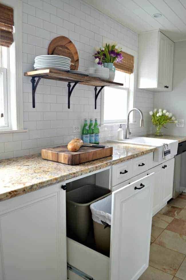 view of kitchen cabinets and DIY garbage can and recycle bin drawer