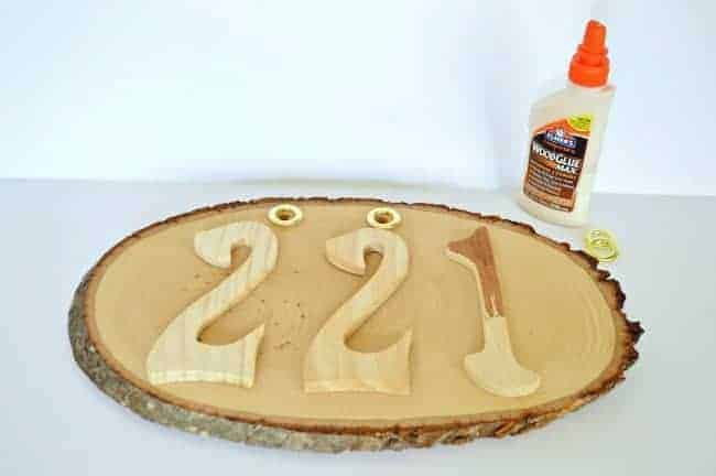 Stained wooden numbers are glued onto a wood round to create DIY rustic house numbers. | www.chatfieldcourt.com