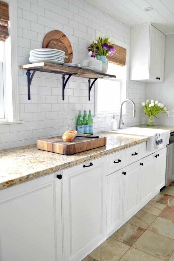 window wall in small white galley kitchen 