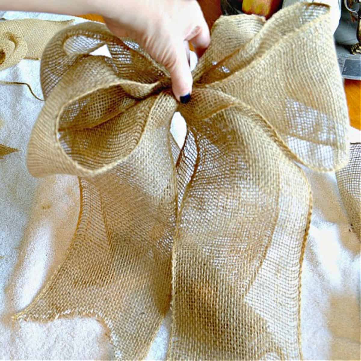 hand holding DIY burlap bow