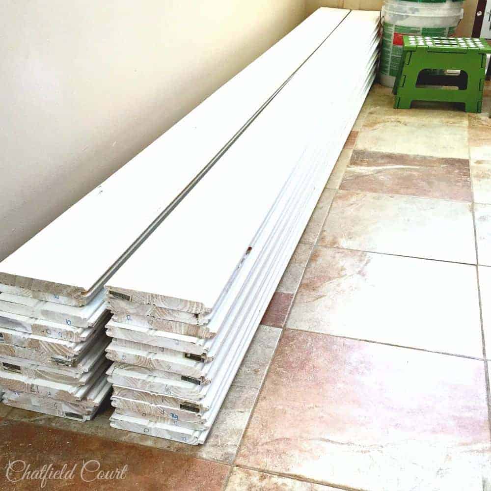 stack of primed tongue and groove planks on kitchen floor