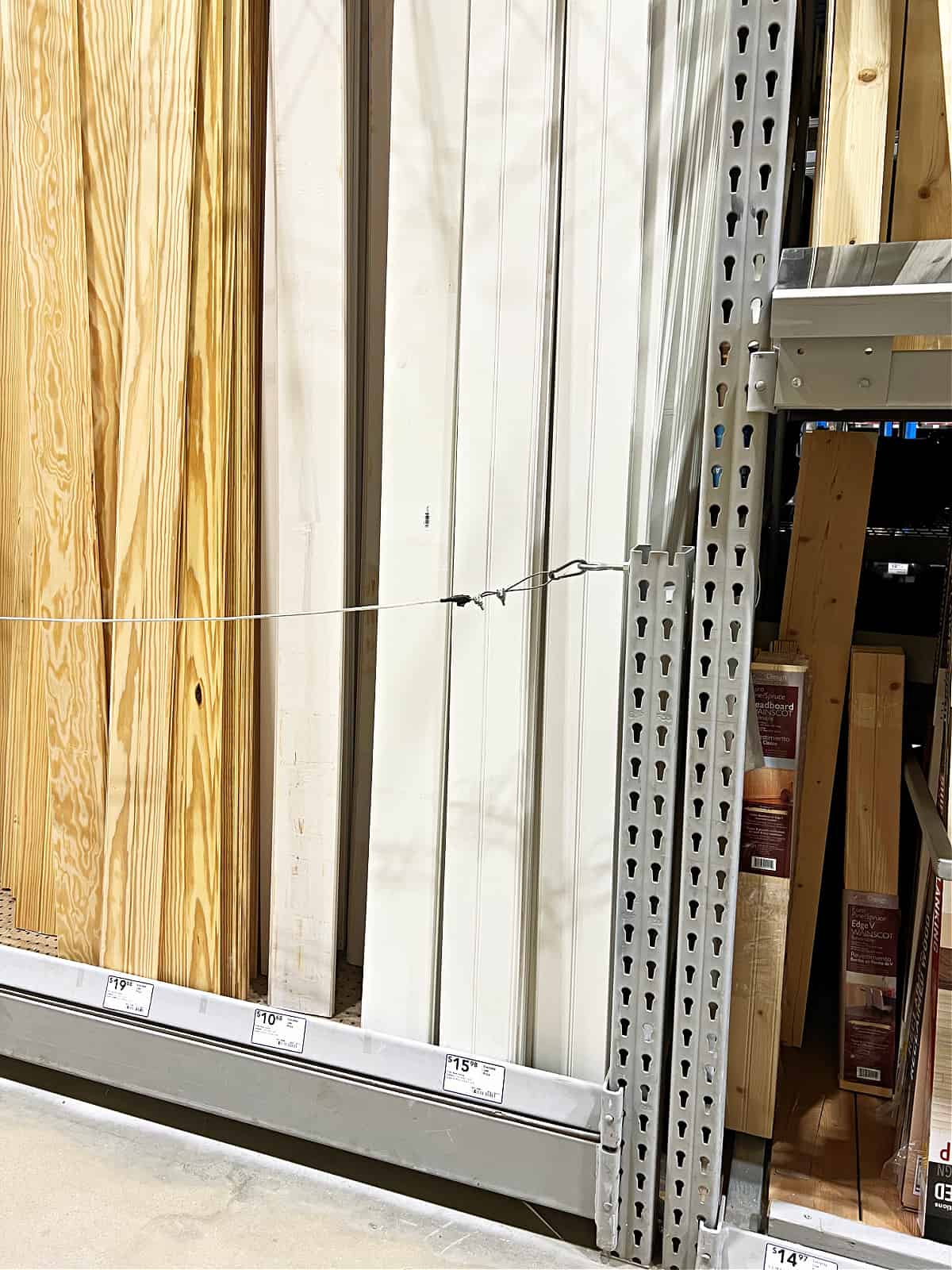 stacked white ceiling planks in a home improvement store