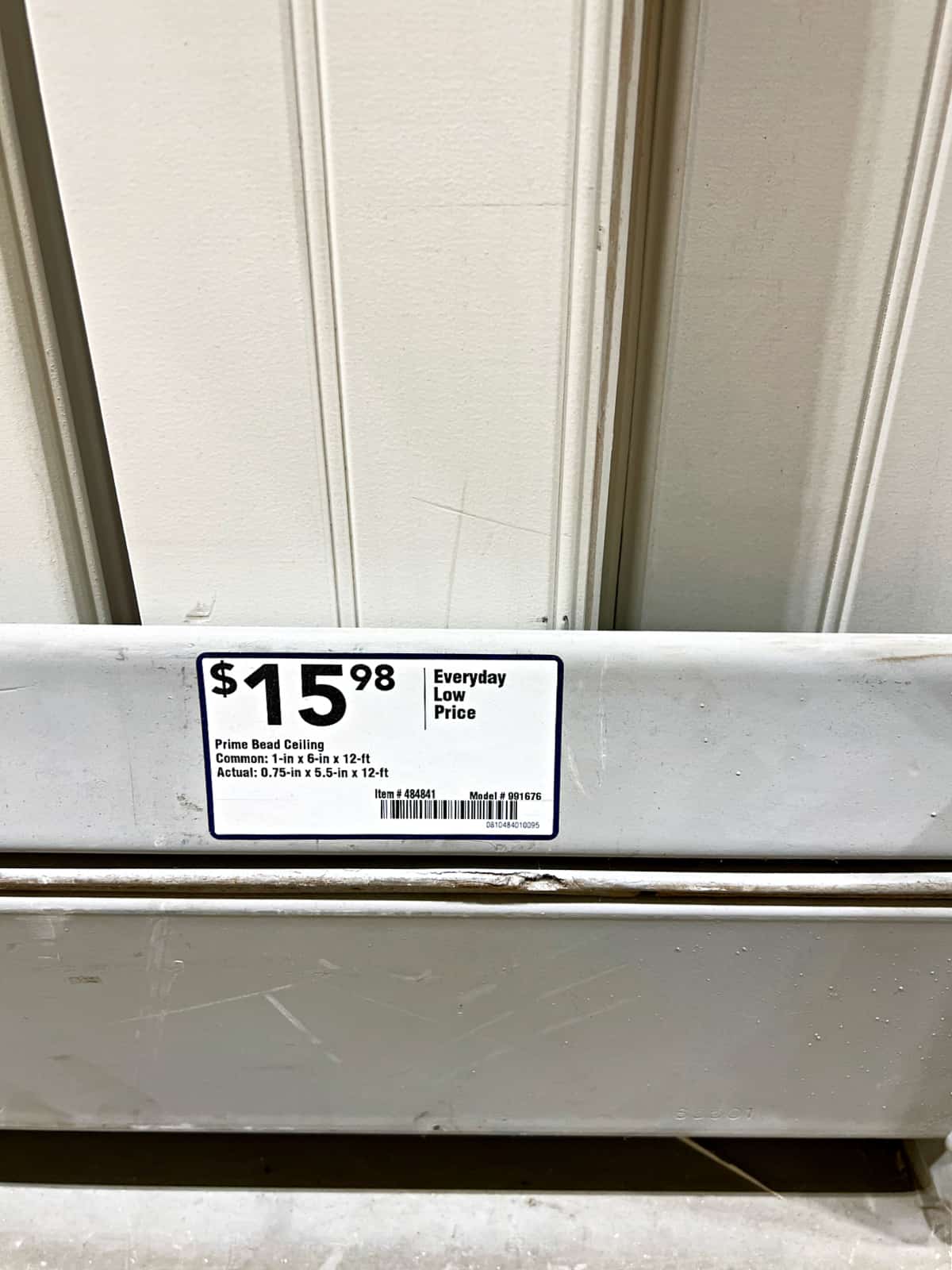 price sticker for white ceiling planks in a home improvement store