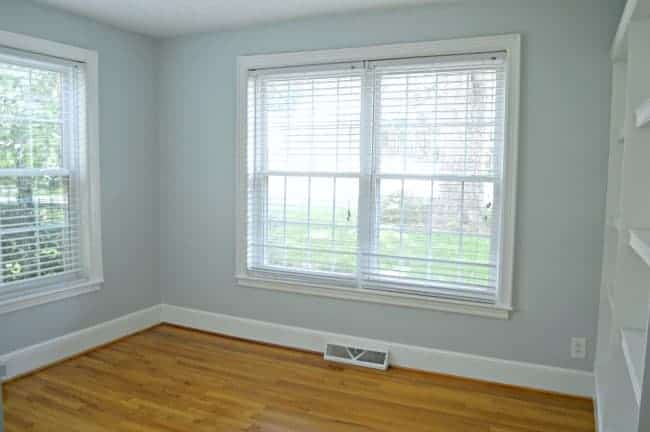 empty guest bedroom painted light blue