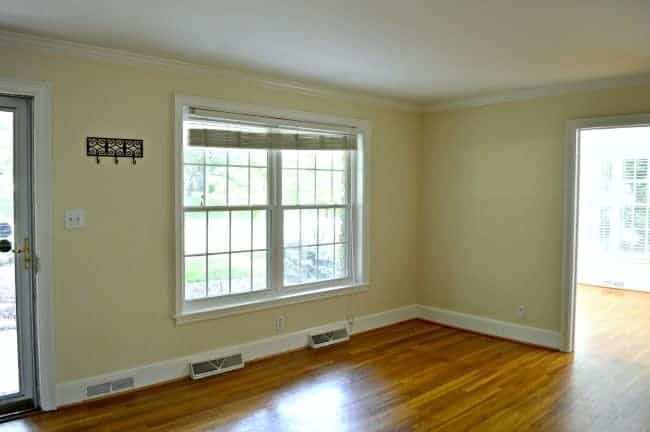 empty living room with yellow walls and hardwood floors