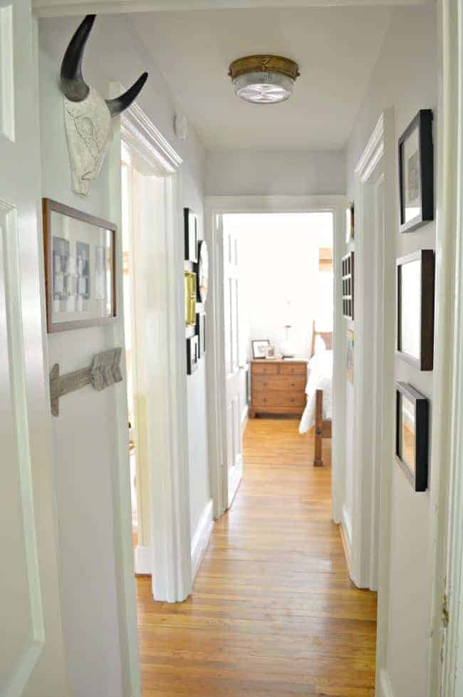 A small hallway redo using gray paint, a bit of farmhouse decor and family photos. www.chatfieldcourt.com