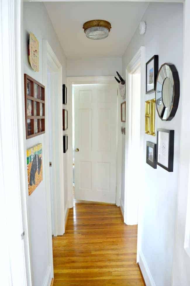 A small hallway redo using gray paint, some farmhouse decor and family photos. www.chatfieldcourt.com