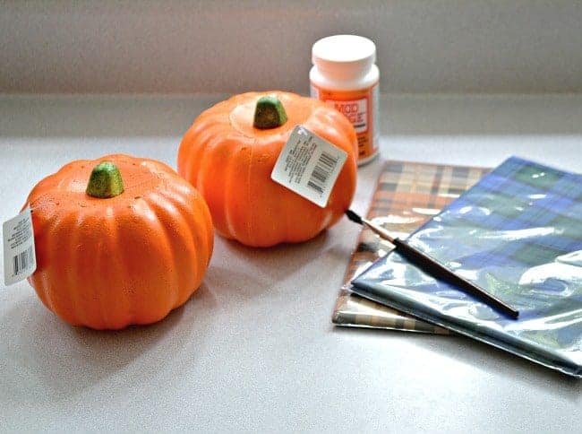 2 Dollar Store pumpkins and packages of wrapping paper