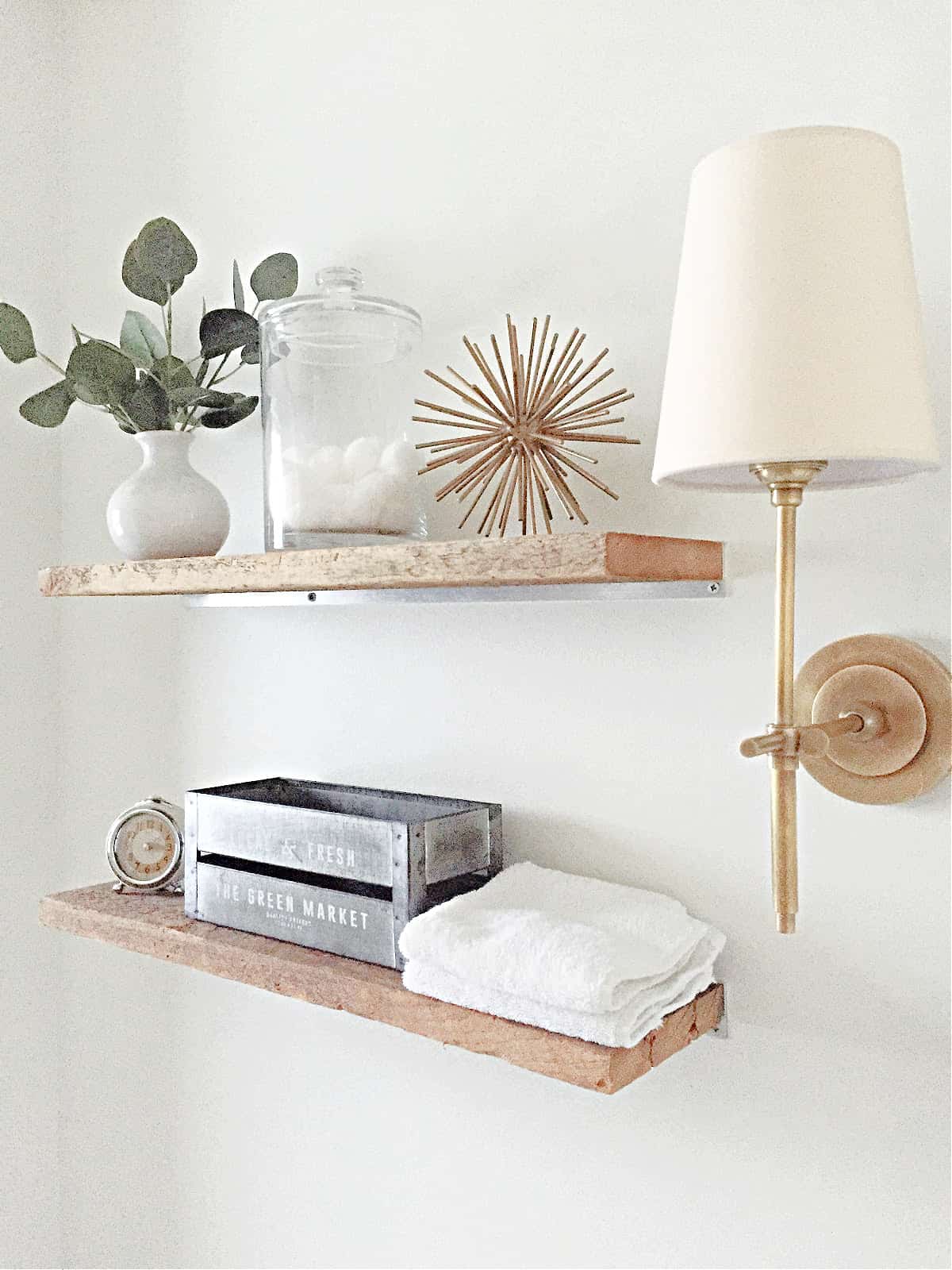 How to add a rustic touch to a small bathroom by installing a couple of DIY faux floating shelves over the toilet for much needed storage. wood shelves in bathroom